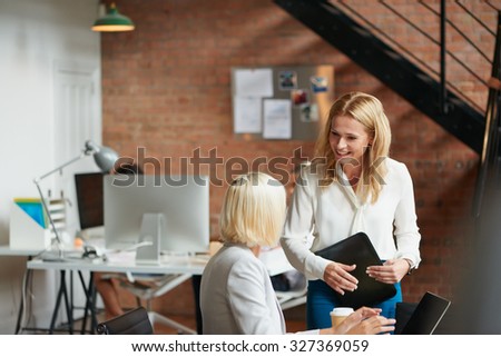 Busy trendy office with business people achieving success