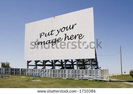 A drive-in movie screen at an angle with words.