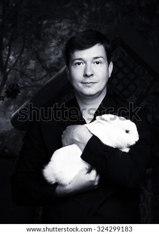 Portrait of a man with a white rabbit on his hands