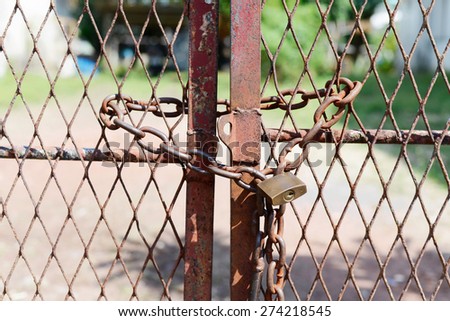 Metal door with rusty chain and key locked. Concept security