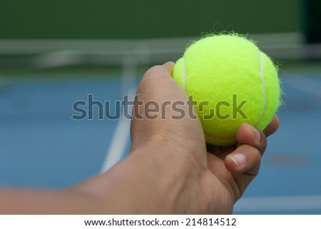 Hand hole yellow tennis ball and serving