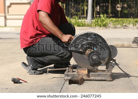 unidentified man using Steel cut machine cut a metal