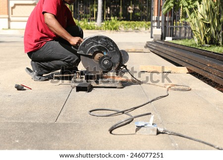 unidentified man using Steel cut machine cut a metal