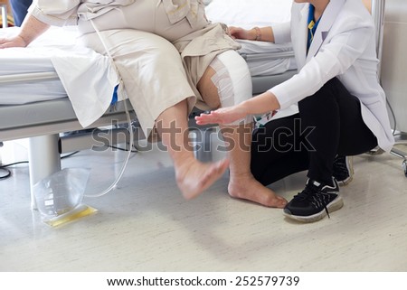 Doctor doing Physical therapy for Patient with a knee injury in hospital