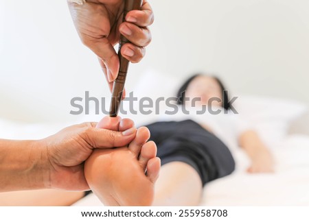 Woman receiving a Reflexology foot massage in spa