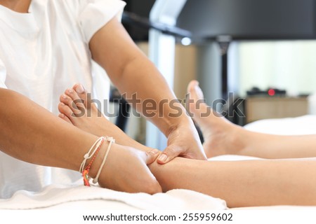 woman receiving and relaxing foot massage at the health spa