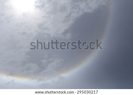 sun halo phenomenon with circular rainbow  in sky with cloud