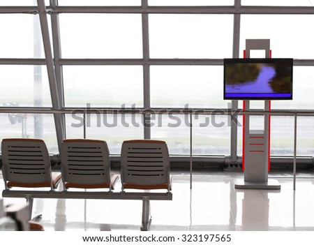 Back of wating chair at airport and television for time table screen in terminal