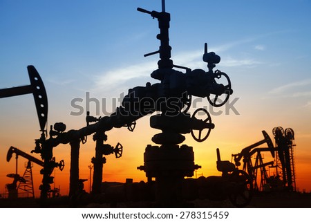 Oil field scene, Oil pipeline and pumping unit of the silhouette