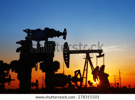 Oil field scene, Oil pipeline and pumping unit of the silhouette