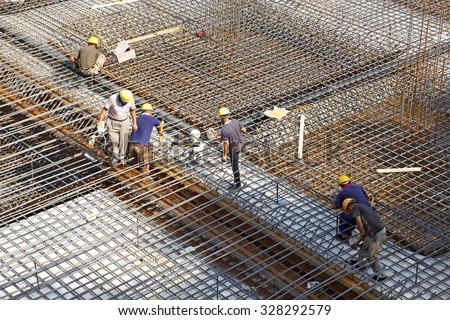 worker in the construction site making reinforcement metal framework for concrete pouring