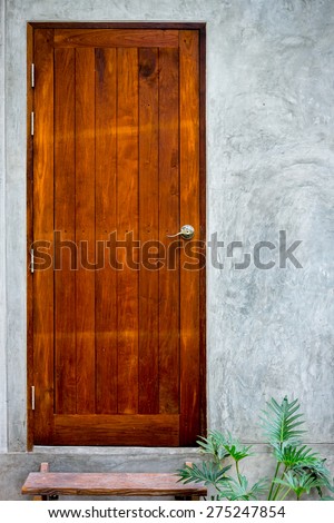 Wooden door on concrete background at coffee shop
