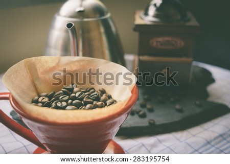 Coffee beans in coffee drip cone vintage color