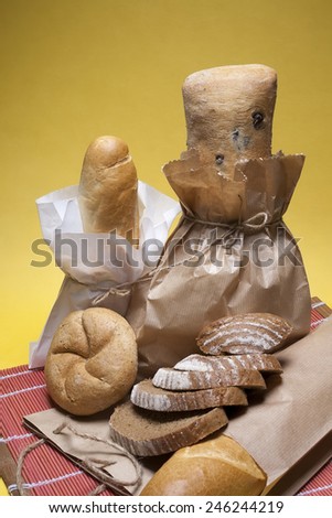 Composition of variety types of bread, packed for sell in recycled paper.