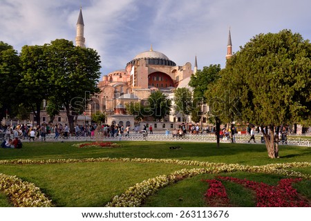 ISTANBUL, TURKEY - JUNE 8, 2014: Tourists rest and socialize in the park in front of Hagia Sophia, located in Istanbul, in Turkey.