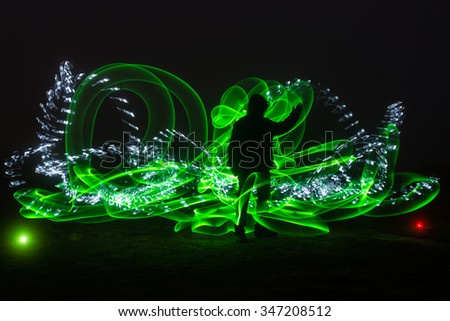 Green light and silhouette / Light painting whit a human silhouette and two types of light, on green background