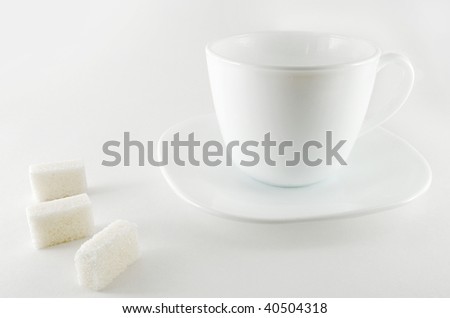 Cup with a three piece sugar on the white