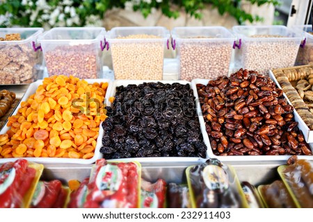 Dried fruits on food store shelf on fruit market. Apricot, peach, plum, banana, nut, date.