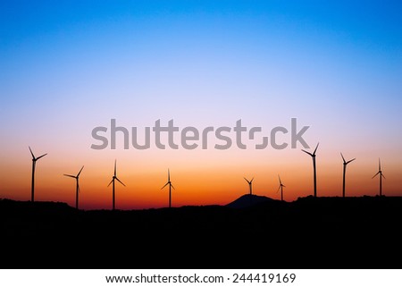 Wind farm and windmills silhouettes in sunset light. Alexigros, Larnaca district, Cyprus.