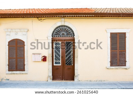 Classic style Mediterranean Europe house entrance, closed window shutters and door.