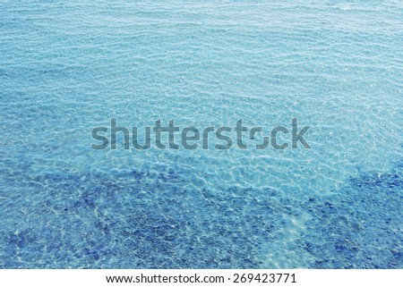 Texture of water. Shallow sea beach with transparent water.