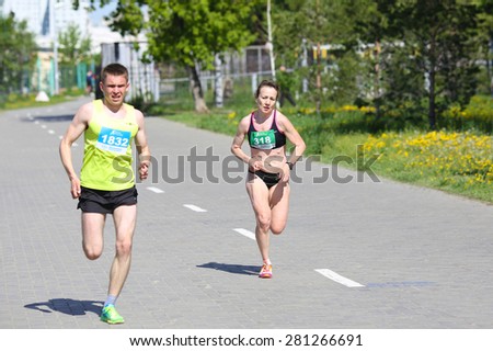 OMSK, RUSSIA - MAY 24 : A group of marathon runners compete at the Spring Half Marathon 2015 in Omsk, Russia, May 24,  2015. Marathon athletes running on street