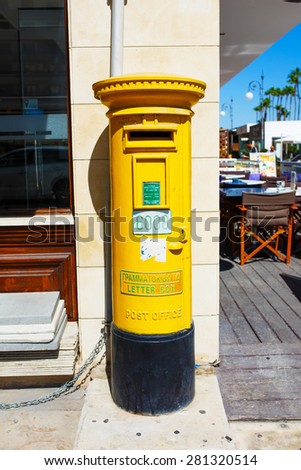 LARNACA, CYPRUS - 3 OCTOBER 2014 - Cyprus Postal Services, government post operator of Cyprus. A legacy of British colonial rule is the use of pillar boxes, repainted yellow after independence.