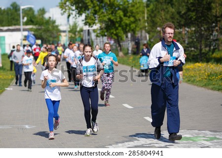 OMSK, RUSSIA - MAY 24 : A group of marathon runners compete at the Spring Half Marathon 2015 in Omsk, Russia, May 24,  2015. Children young marathon athletes running on street