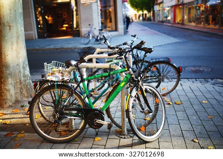 Parked Bicycles On Sidewalk. Bike Parking On The Street.