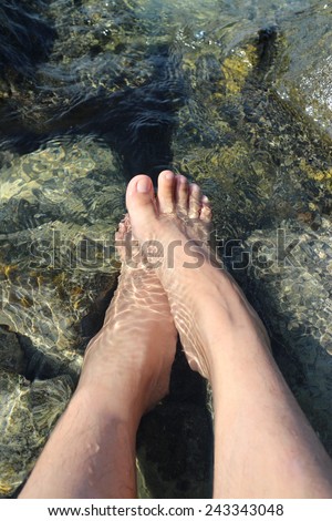 Feet on stone and sea that make feel so good and relax day of weekend.