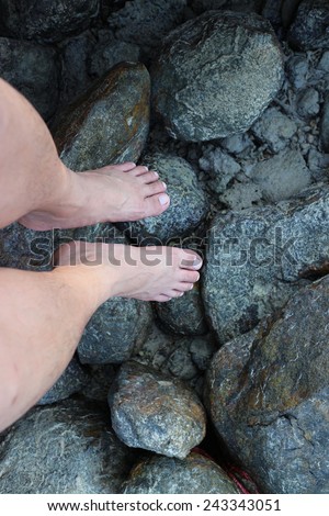Feet on stone and sea that make feel so good and relax day of weekend.