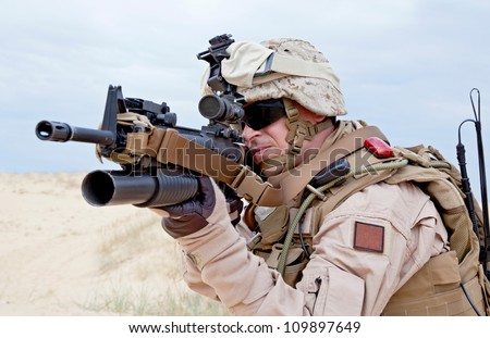 US marine aiming a gun with grenade launcher