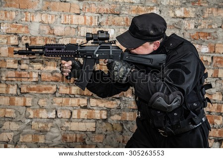 Special forces operator in black uniform and bulletproof