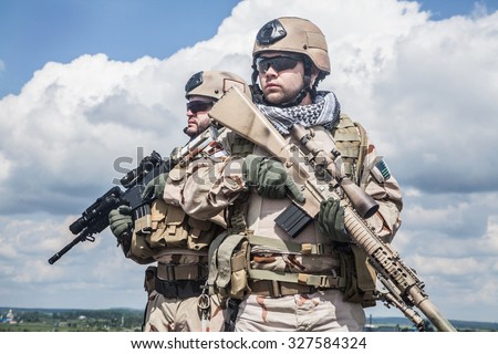 Navy SEALs Team with weapons in action