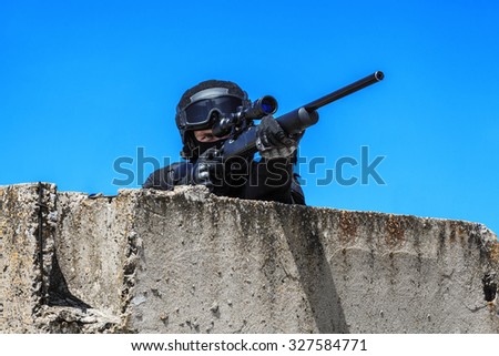 Police sniper SWAT in black uniform in action