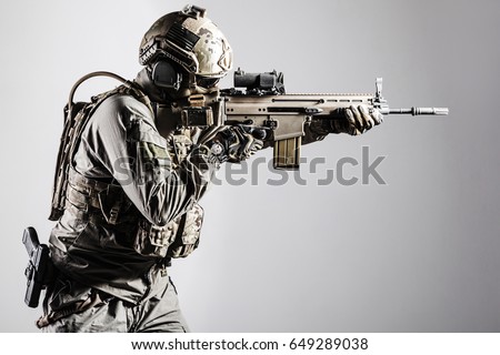 Army soldier in Protective Combat Uniform holding Special Operations Forces Combat Assault Rifle. Shooting weapon close up. Studio shot, isolated on white background