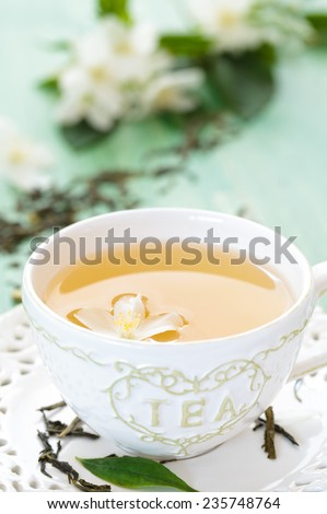 Cup of green tea with flowers of  jasmine.