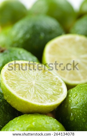 Backgrounds. Close up shot of wet  limes. Focus on the central part of sliced lime.