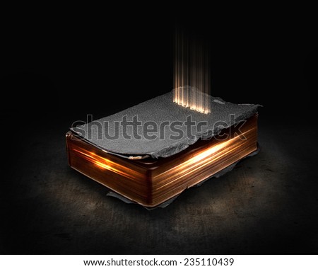 Glowing Bible with light coming from the pages.
