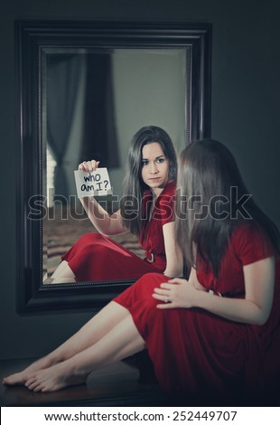 A woman looking into a mirror and asking \