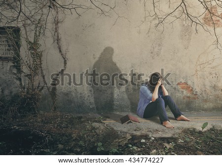 Shadow of Jesus comforts a sad woman.