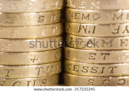 Two stacks of UK pound coins forming a background