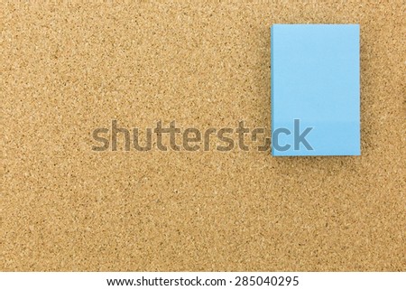 blue post it on cork board