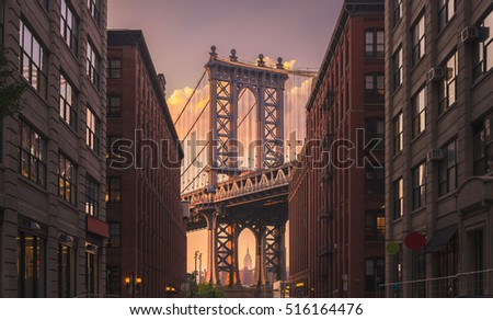 Manhattan bridge seen from a brick buildings in Brooklyn street in perspective, New York, USA. Shot in the evening