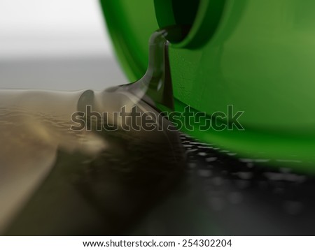 a green metal oil drum spilling clean oil onto the ground over cast shadow