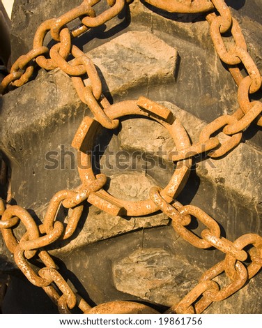 Close-up of snow chain on a big tire use in forest machinery