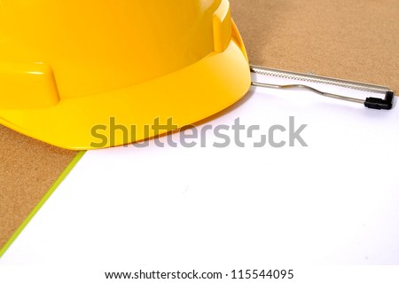 Yellow hard hat and clipboard. You can put your design on the clipboard