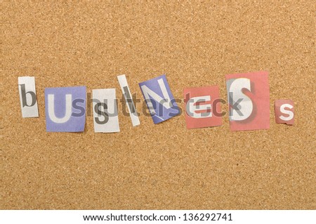 Business word made from newspaper letter shot over pinboard background