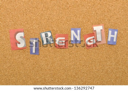 Strenght word made from newspaper letter shot over pinboard background
