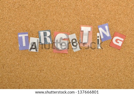 Targeting word made from newspaper letter shot over pinboard background
